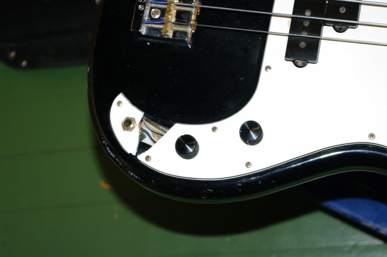 The pickguard is broken, a piece has fallen out just above the jack